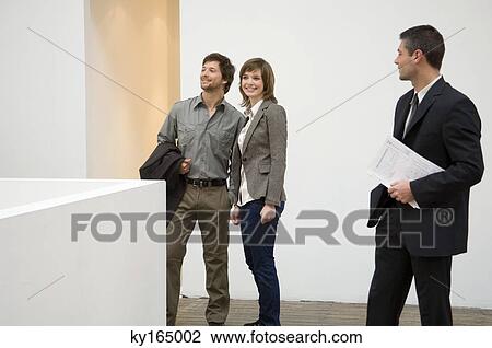 Real estate agent looking at a couple View Large Photo Image Stock Image - Real estate agent looking at a couple. Fotosearch