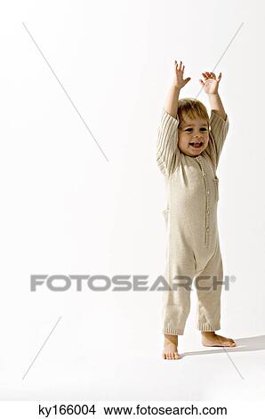 Baby boy standing with his arms raised and smiling View Large Photo Image Picture - Baby boy standing with his arms raised and smiling. Fotosearch