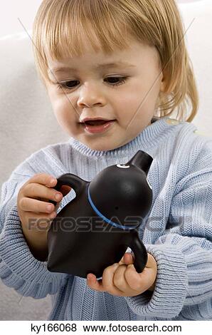 Close-up of a baby boy holding a baby cup View Large Photo Image Stock Photo - Close-up of a baby boy holding a baby cup. Fotosearch