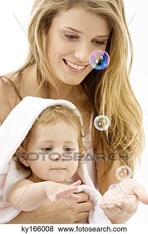 Close-up of a young woman and her son playing with soap bubbles View Large Photo Image Stock Photo - Close-up of a young woman and her son playing with soap bubbles. Fotosearch
