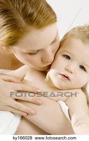 Close-up of a young woman kissing her son View Large Photo Image Stock Photo - Close-up of a young woman kissing her son. Fotosearch