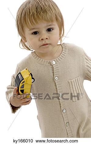 Portrait of a baby boy holding a toy car View Large Photo Image Stock Image - Portrait of a baby boy holding a toy car. Fotosearch