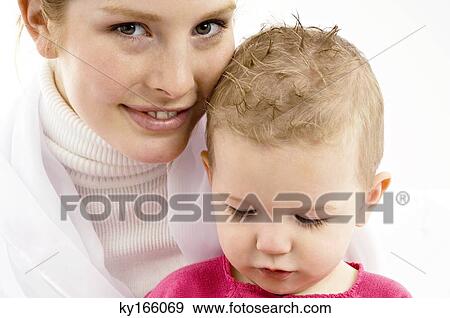 Portrait of a young woman smiling with her son View Large Photo Image Stock Photo - Portrait of a young woman smiling with her son. Fotosearch