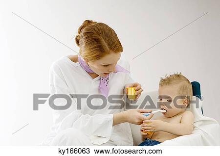 Young woman feeding to her son View Large Photo Image Stock Image - Young woman feeding to her son. Fotosearch