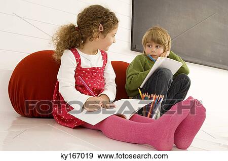 Boy and a girl drawing on notepads View Large Photo Image Stock Photo - Boy and a girl drawing on notepads. Fotosearch