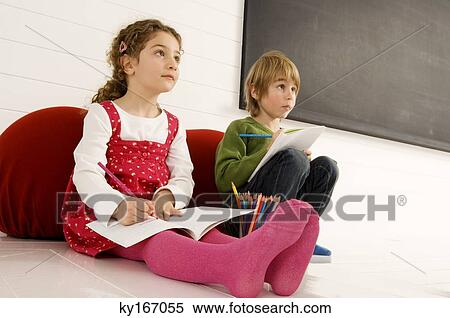 Boy and a girl drawing on notepads View Large Photo Image Stock Photography - Boy and a girl drawing on notepads. Fotosearch