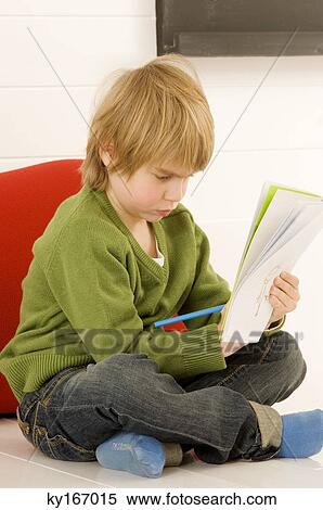 Stock Photography - Boy drawing on a notepad. Fotosearch