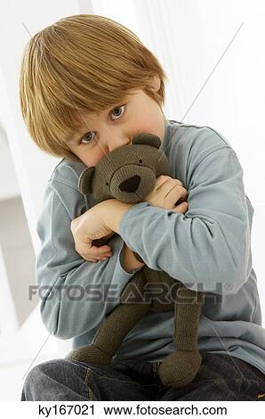 Boy holding a teddy bear View Large Photo Image Stock Image - Boy holding a teddy bear. Fotosearch