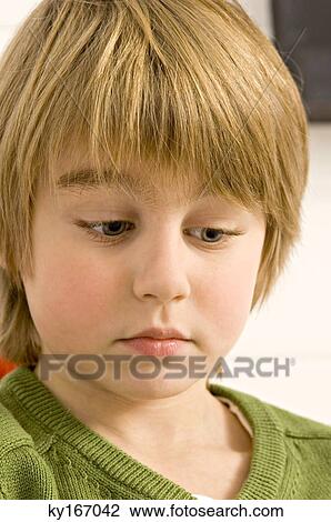Stock Image - Close-up of a boy looking serious. Fotosearch