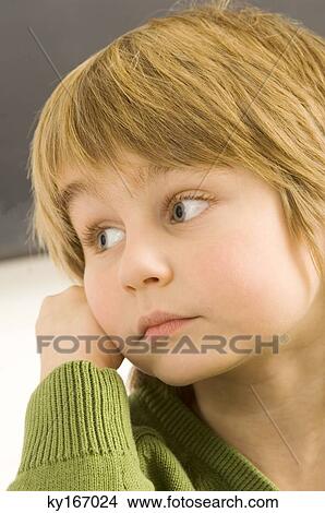 Picture - Close-up of a boy thinking. Fotosearch