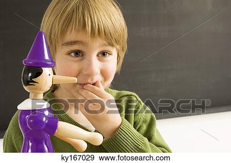 Close-up of a boy with a toy View Large Photo Image Stock Photo - Close-up of a boy with a toy. Fotosearch
