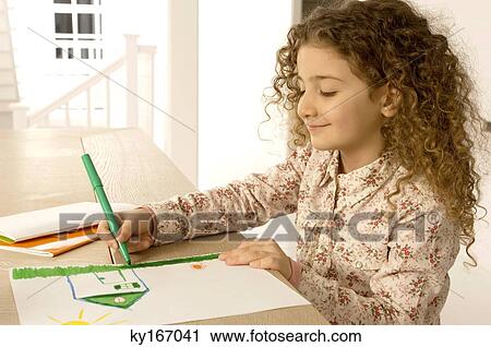 Close-up of a girl coloring on a sheet of paper View Large Photo Image Stock Image - Close-up of a girl coloring on a sheet of paper. Fotosearch