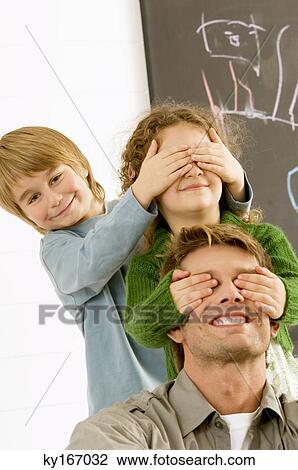 Girl covering eyes of her father and her eyes covered by her brother View Large Photo Image Stock Image - Girl covering eyes of her father and her eyes covered by her brother. Fotosearch