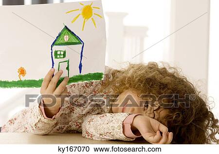 Girl showing a drawing and smiling View Large Photo Image Stock Image - Girl showing a drawing and smiling. Fotosearch