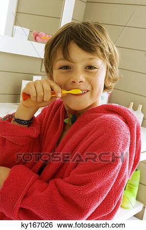 Stock Photograph - Portrait of a boy brushing his teeth. Fotosearch