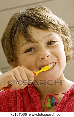 Stock Photography - Portrait of a boy brushing his teeth. Fotosearch