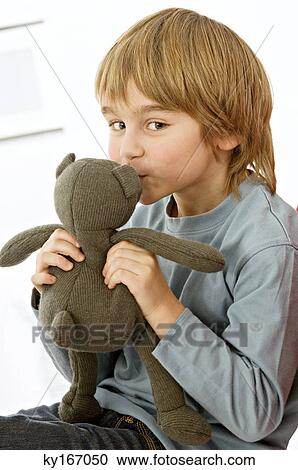 Portrait of a boy kissing a teddy bear View Large Photo Image Stock Image - Portrait of a boy kissing a teddy bear. Fotosearch
