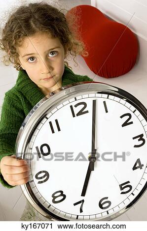 Portrait of a girl holding a clock View Large Photo Image Stock Image - Portrait of a girl holding a clock. Fotosearch