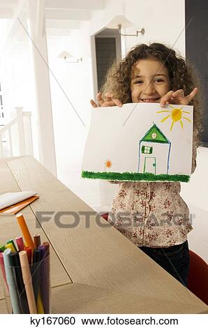 Portrait of a girl showing a drawing View Large Photo Image Stock Image - Portrait of a girl showing a drawing. Fotosearch