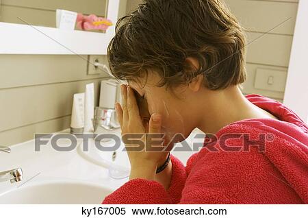 Stock Photography - Side profile of a boy washing his face. Fotosearch
