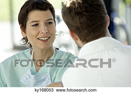 Close-up of a female doctor discussing with a male doctor View Large Photo Image Stock Image - Close-up of a female doctor discussing with a male doctor. Fotosearch