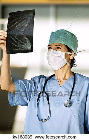 Close-up of a female doctor examining an X-Ray image View Large Photo Image Stock Photo - Close-up of a female doctor examining an X-Ray image. Fotosearch