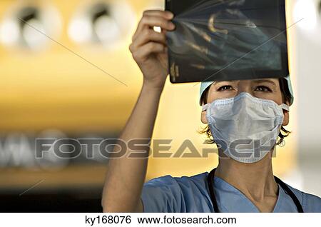 Close-up of a female doctor examining an X-Ray image View Large Photo Image Stock Photograph - Close-up of a female doctor examining an X-Ray image. Fotosearch