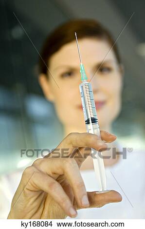 Close-up of a female doctor holding a syringe View Large Photo Image Picture - Close-up of a female doctor holding a syringe. Fotosearch