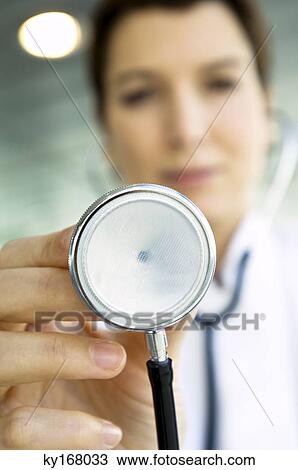 Close-up of a female doctor holding a stethoscope View Large Photo Image Stock Image - Close-up of a female doctor holding a stethoscope. Fotosearch