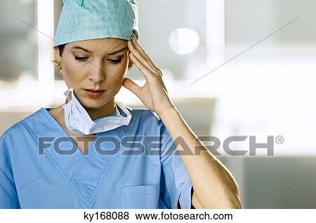 Close-up of a female doctor looking stressed View Large Photo Image Stock Photo - Close-up of a female doctor looking stressed. Fotosearch