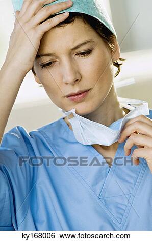 Close-up of a female doctor looking stressed View Large Photo Image Stock Photograph - Close-up of a female doctor looking stressed. Fotosearch