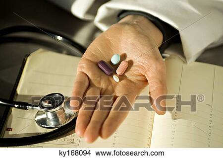 Close-up of pills on a doctor's palm View Large Photo Image Picture - Close-up of pills on a doctor's palm. Fotosearch