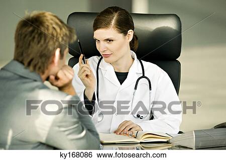 Female doctor explaining to a patient View Large Photo Image Stock Photograph - Female doctor explaining to a patient. Fotosearch
