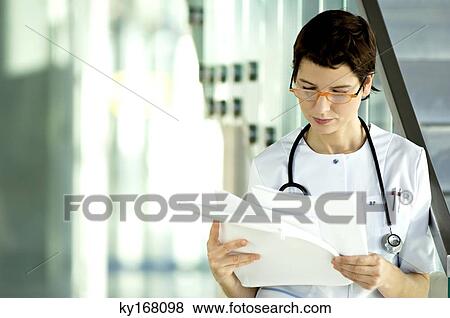 Female doctor reading medical records View Large Photo Image Stock Photo - Female doctor reading medical records. Fotosearch
