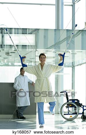 Female patient standing on one leg and holding crutches View Large Photo Image Stock Photo - Female patient standing on one leg and holding crutches. Fotosearch