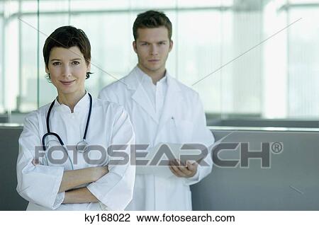 Portrait of a female and a male doctor standing together View Large Photo Image Stock Image - Portrait of a female and a male doctor standing together. Fotosearch