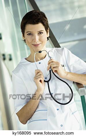 Portrait of a female doctor holding a stethoscope View Large Photo Image Stock Photography - Portrait of a female doctor holding a stethoscope. Fotosearch