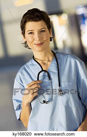 Portrait of a female doctor smiling View Large Photo Image Stock Image - Portrait of a female doctor smiling. Fotosearch