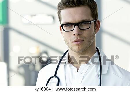 Portrait of a male doctor with a stethoscope around his neck View Large Photo Image Stock Image - Portrait of a male doctor with a stethoscope around his neck. Fotosearch
