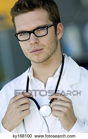 Stock Image - Portrait of a male doctor with a stethoscope around his neck. Fotosearch