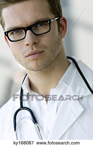 Portrait of a male doctor with a stethoscope around his neck View Large Photo Image Stock Photo - Portrait of a male doctor with a stethoscope around his neck. Fotosearch