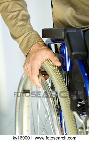 Close-up of a man sitting in a wheelchair View Large Photo Image Stock Image - Close-up of a man sitting in a wheelchair. Fotosearch