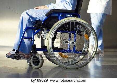 Low section view of a patient sitting in a wheelchair View Large Photo Image Stock Photo - Low section view of a patient sitting in a wheelchair. Fotosearch