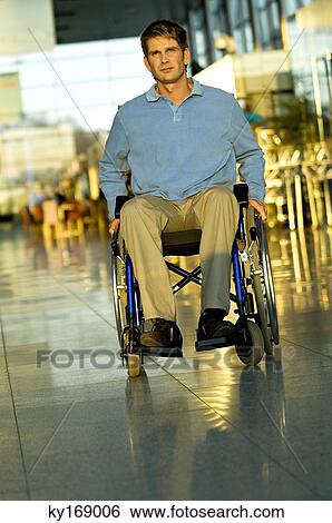 Mid adult man sitting in a wheelchair View Large Photo Image Stock Photograph - Mid adult man sitting in a wheelchair. Fotosearch
