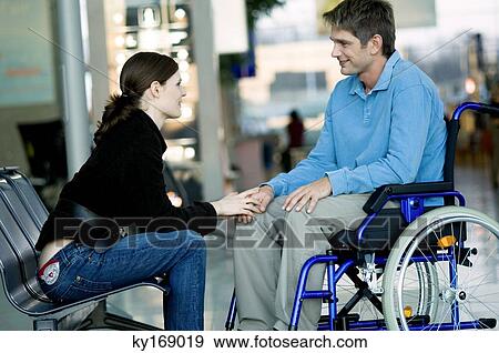 Side profile of a young woman talking with a mid adult man View Large Photo Image Stock Photo - Side profile of a young woman talking with a mid adult man. Fotosearch