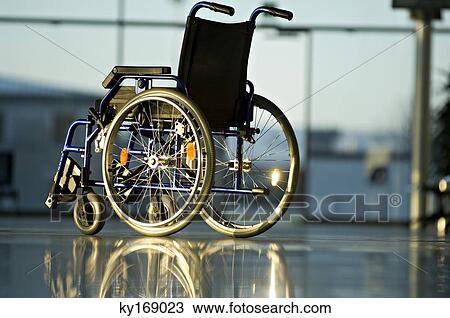 Wheelchair in a corridor of a hospital View Large Photo Image Stock Image - Wheelchair in a corridor of a hospital. Fotosearch