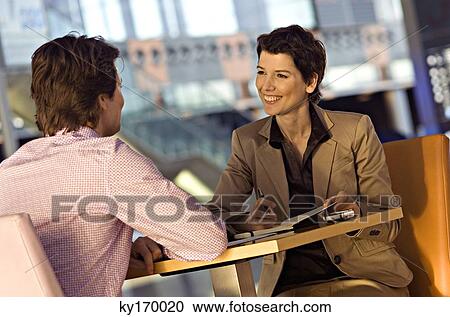 Businessman and a businesswoman in a meeting View Large Photo Image Stock Image - Businessman and a businesswoman in a meeting. Fotosearch