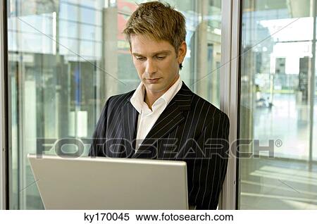 Stock Photography - Businessman using a laptop. Fotosearch