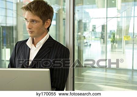 Businessman using a laptop View Large Photo Image Stock Photography - Businessman using a laptop. Fotosearch