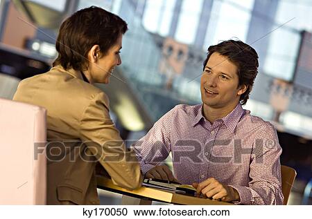 Businesswoman and a businessman in a meeting View Large Photo Image Stock Image - Businesswoman and a businessman in a meeting. Fotosearch